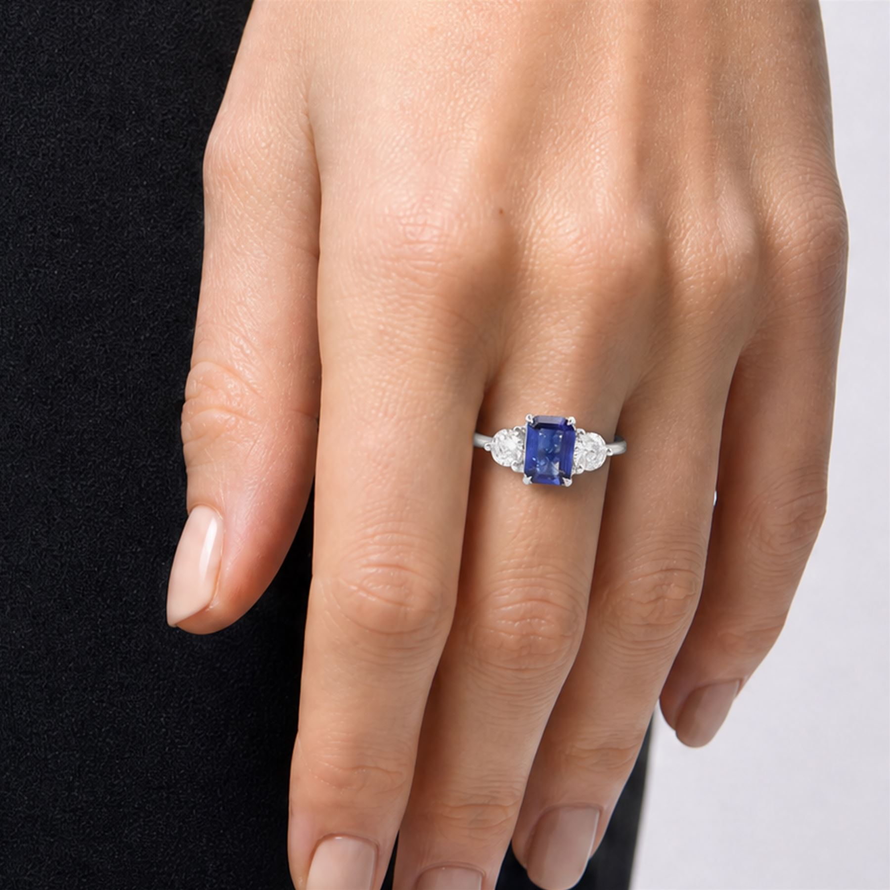 Platinum sapphire and diamond three stone ring, single emerald cut sapphire of approx 0.70 carat, either side set with two round brilliant cut diamonds, hallmarked, total diamond weight approx 0.50 carat