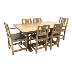 'Lizardman' oak refectory dining table with rectangular adzed top, twin pillar supports on sledge feet connected by floor stretcher (168cm x 90cm, H74cm), and set six (4+2) oak dining chairs with lattice carved backs, drop in upholstered seat cushions, all by Derek Slater of Crayke