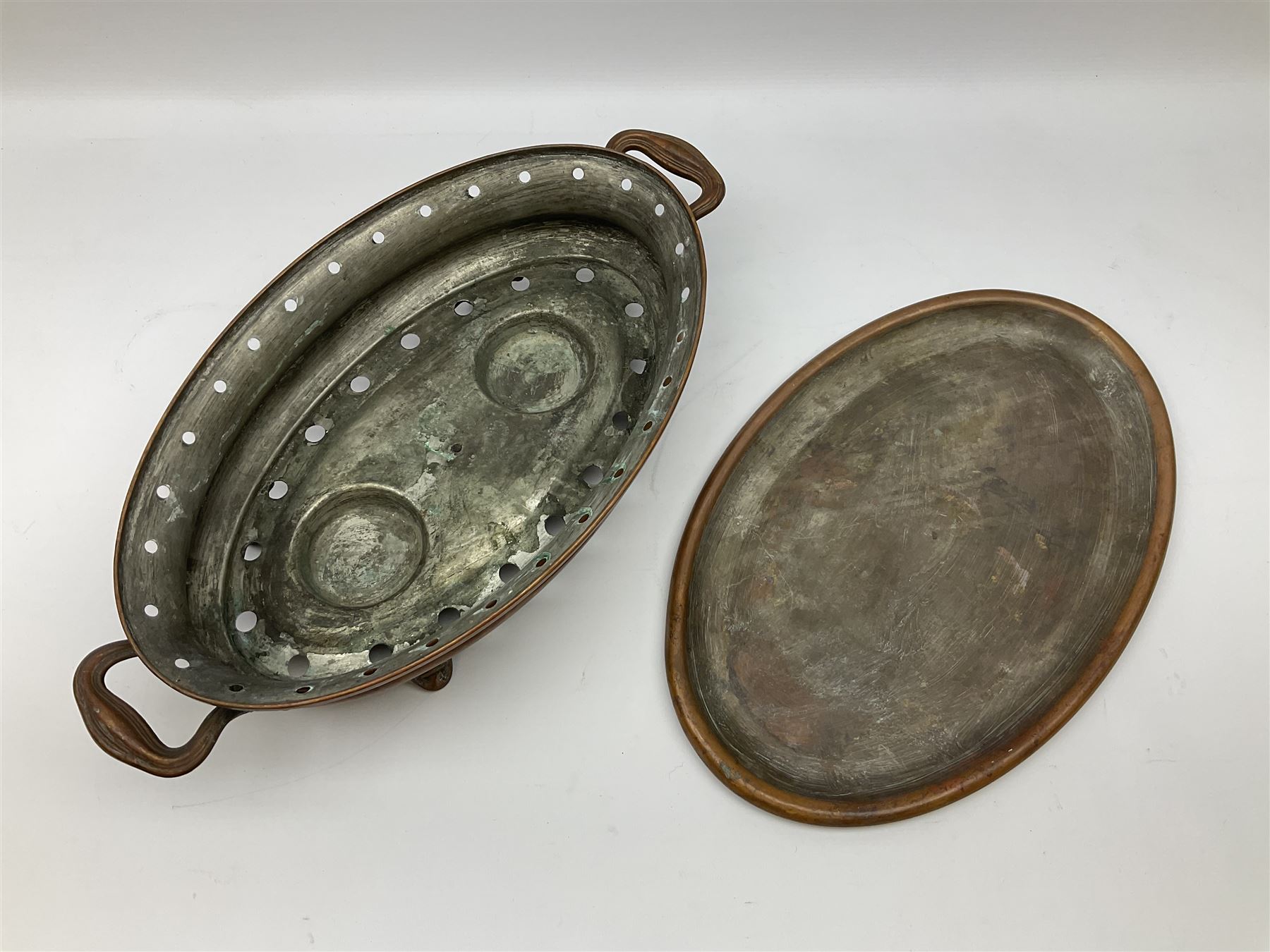 Agricultural copper corn funnel, H32.5cm, another similar copper funnel and copper warming platter of oval form, with twin handles on four supports, with removeable warming plate, L49cm