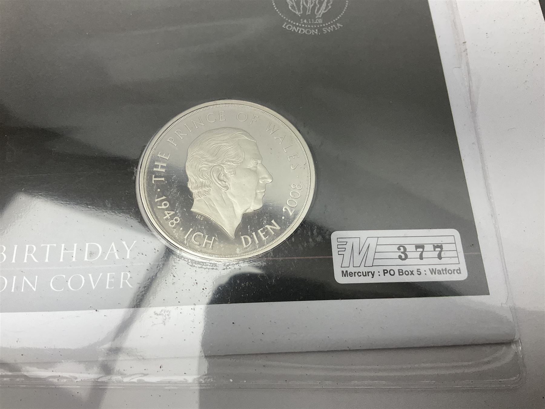 Queen Elizabeth II 2000 'The Queen Mother' silver proof five pound coin, 2000 'Millennium' silver proof five pounds, 2007 'Scouts' silver proof fifty pence, Tristan Da Cunha 2014 9ct gold 1 gram gold one crown coin, all cased with certificates and a 'Prince Charles 60th Birthday Commemorative Coin Cover' containing a 2008 silver proof five pound coin in folder (5)