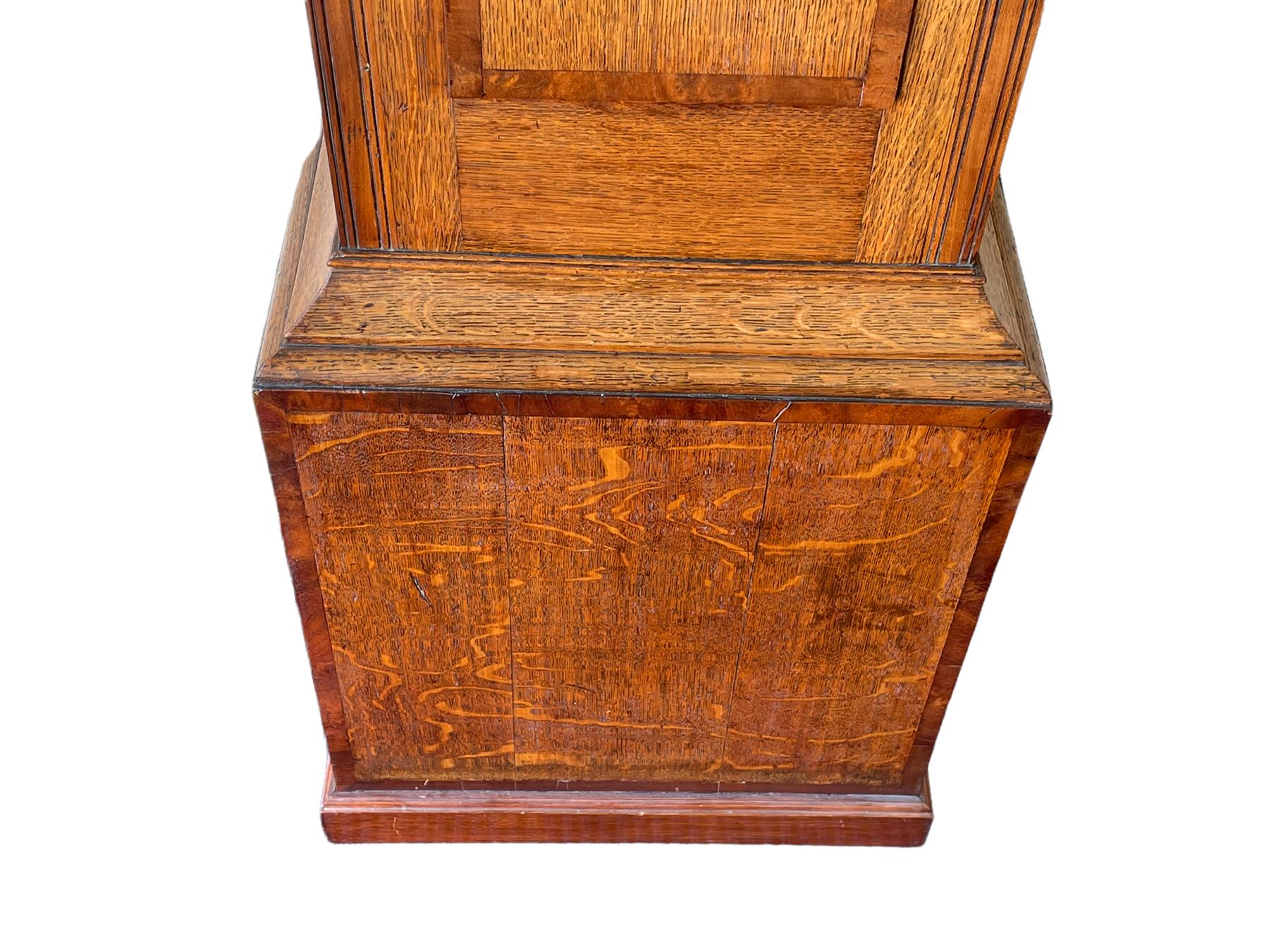 An oak and mahogany longcase clock by William Hewson, Lincoln c 1860, with a swans neck pediment, ball and spire finials and brass paterae, break arch hood door flanked by reeded pilasters with brass capitals, oak trunk with canted corners and a short oak door with mahogany crossbanding, conforming plinth with applied skirting, fully painted dial with Roman numerals, minute track and subsidiary seconds dial, matching brass stamped hands and winding collets, depiction of a  sportsman to the break arch and corresponding game birds to the spandrels, dial pinned directly to an eight-day rack striking movement with a recoil anchor escapement, striking the hours on a bell. Original casemakers label pasted to the inside of the case 