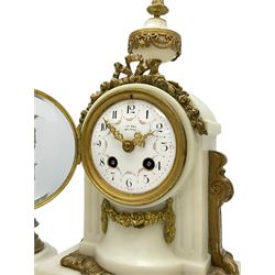 An early 20th century white marble mantle clock in a break front case with an arched top and finial, gilded scroll work to the sides and pierced foliate panels to the front, plinth raised on five bun feet, enamel dial with garland decoration, Arabic numerals, minute markers and Louis XV gilt hands, within a convex glazed bezel, eight-day Parisian striking movement striking the hours and half hours on a bell, with two conforming single light candlesticks. With Pendulum.

