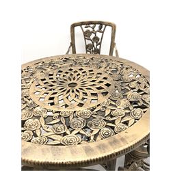 Hardened plastic garden table and four chairs, brushed gold, floral top, four supports, joining undertier, (D99cm, H71cm) matching chairs, four supports and joining undertier (W56cm)