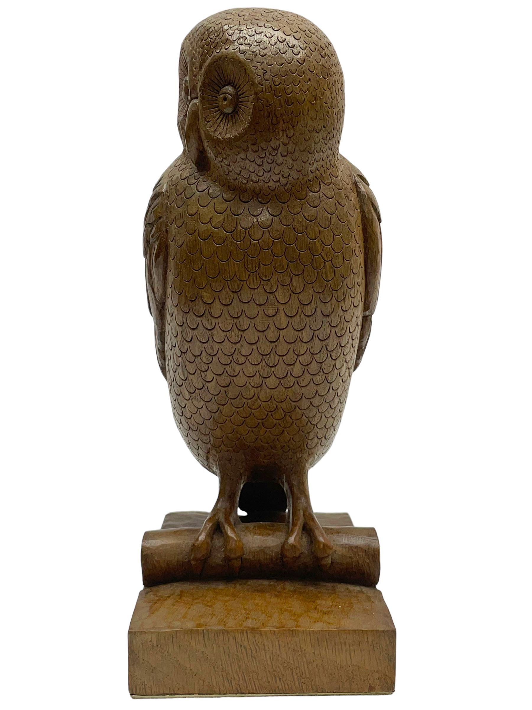 Acornman - carved oak owl perched on branch, on tooled block plinth carved with acorn signature, by the workshop of Alan Grainger, Brandsby (carved by Norman Darnley)