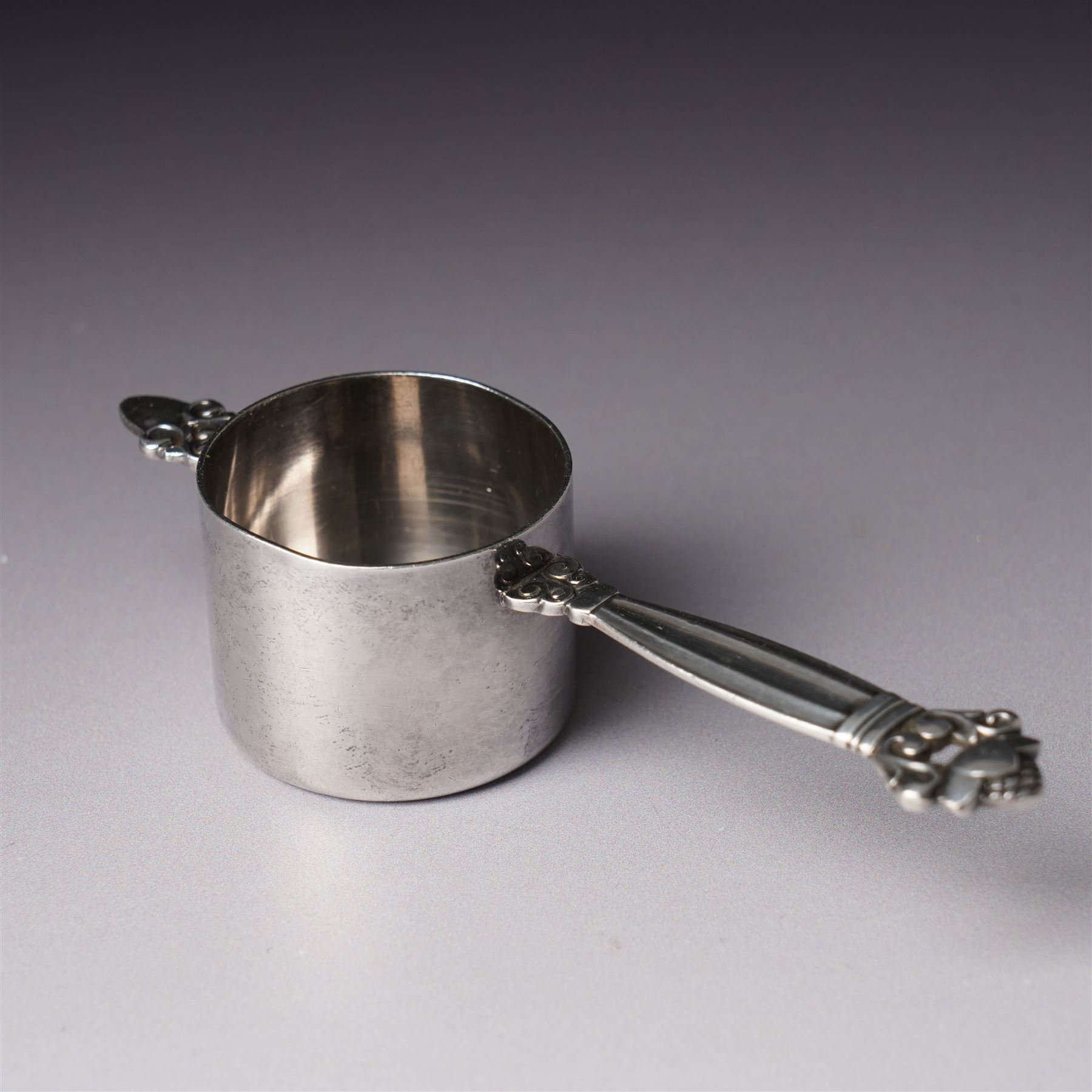 Georg Jensen sterling silver spirit measure of Art Deco design with flattened handle and a silver sugar caster Birmingham 1959