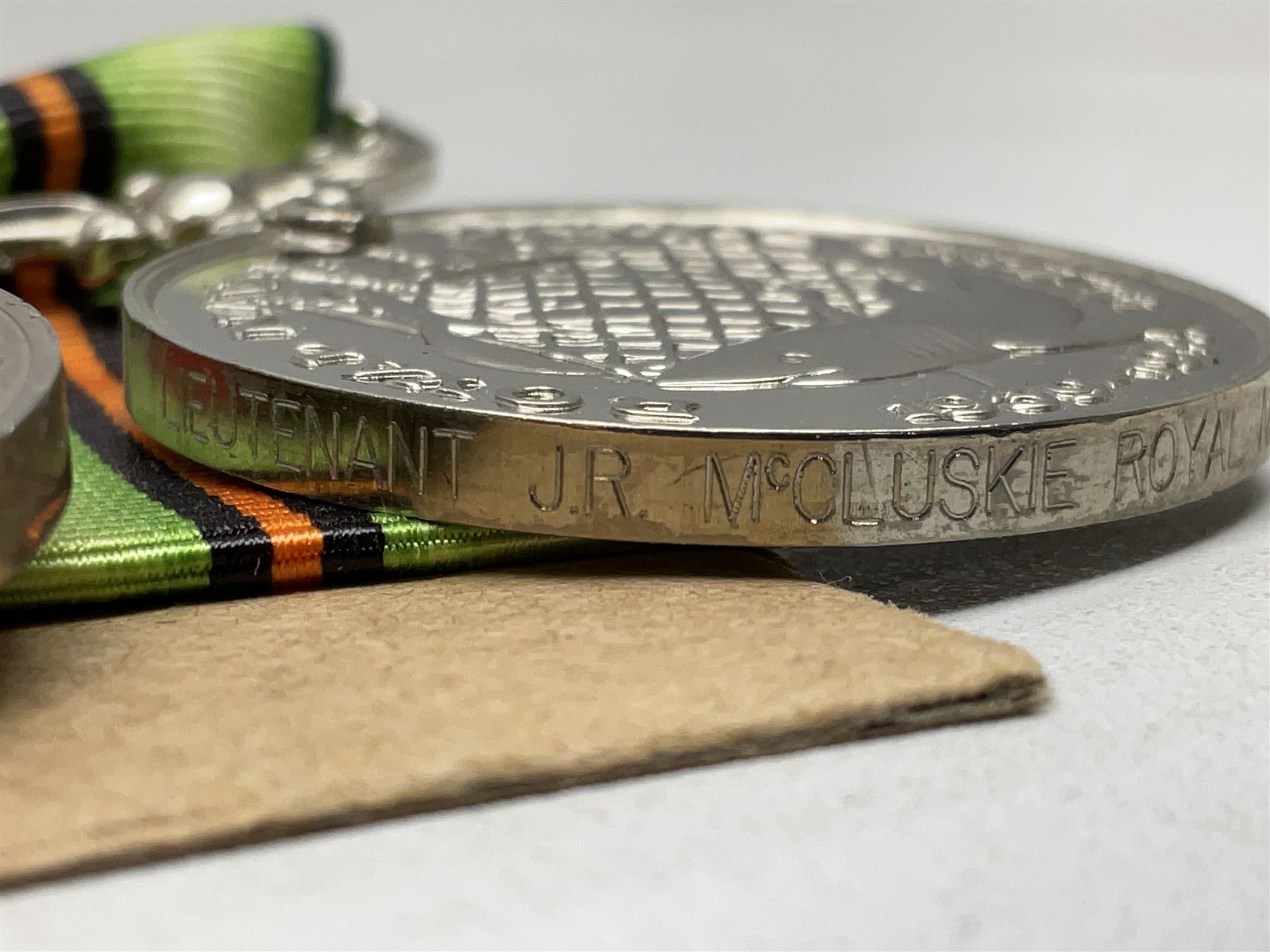 WW2 Royal Naval group of eight medals comprising OBE, hallmarked silver Distinguished Service Cross inscribed verso Lieut. J.R. McCluskie RNVR 1945, 1939-1945 Star, Atlantic Star, Africa Star, 1939-1945 War Medal, Defence Medal and Royal Naval Patrol Service Medal inscribed Lieutenant J.R. McCluskie Royal Naval Patrol Service; with seven original photographs of a sea battle 27th November 1940 against the Italian Fleet and another photographic postcard of Sir Stafford Cripps arriving on board one of the vessels.