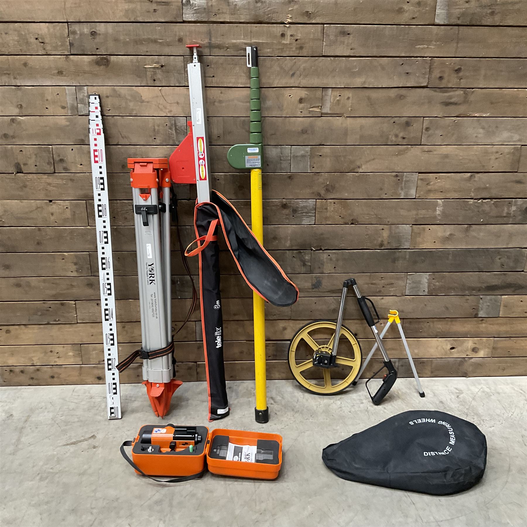 Collection of surveyors equipment including an automatic level and tripod stand and Hilka Pro Craft distance measuring wheel