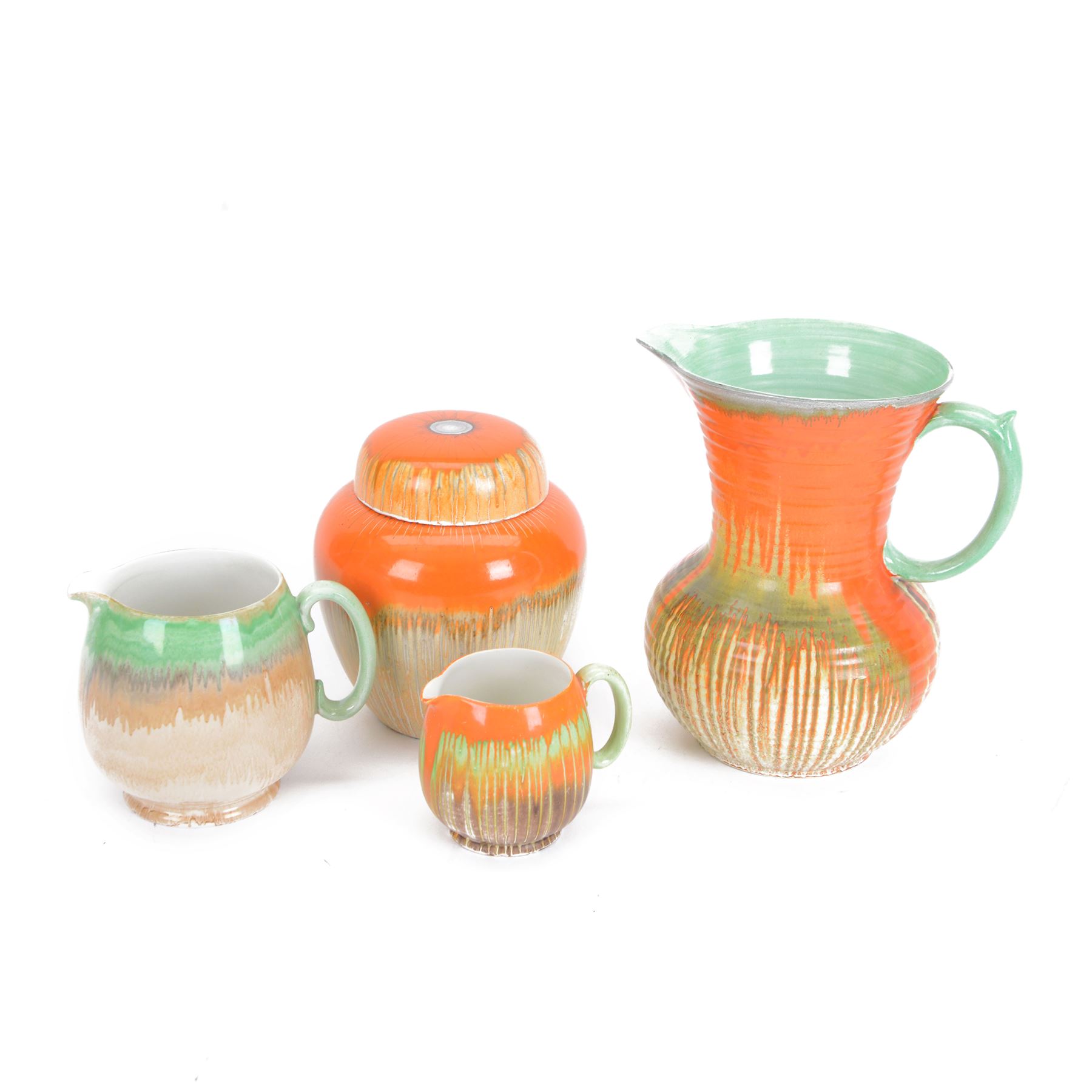 Four pieces of Shelley Harmony dripware, comparing ginger jar and three jugs, largest jug H23cm