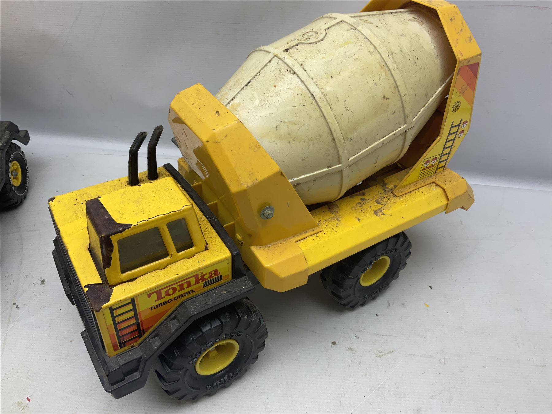Tonka - five large scale pressed steel vehicles comprising Cement Mixer, Mobile Crane, Bulldozer and two Dumper Trucks (5)