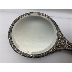 Silver mounted dressing table mirror, embossed with birds, masks, and foliate and C scrolls, hallmarked Birmingham, and fruit knife with mother of pearl handle and silver blade, (2)