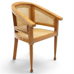 Late 20th century Anglo-Indian teak framed bergère armchair with canework back and seat, raised on tapering supports
Provenance: purchased Liberty & Co in the 1990s from the oriental line