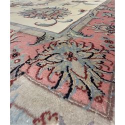 North East Persian Kashmar hand-knotted rug, ivory field with an all-over design of linked floral medallions and scrolling vines with a central circular medallion enclosed by multiple borders and a main broad madder field with palmettes and arabesques, 248cm x 145cm