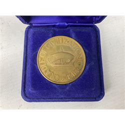 Queen Elizabeth II cradle of civilization cruise 1976 bronze medallion with related book and two other Queen Elizabeth II commemorative medallions for cruises in 1975 and 1976, all cased