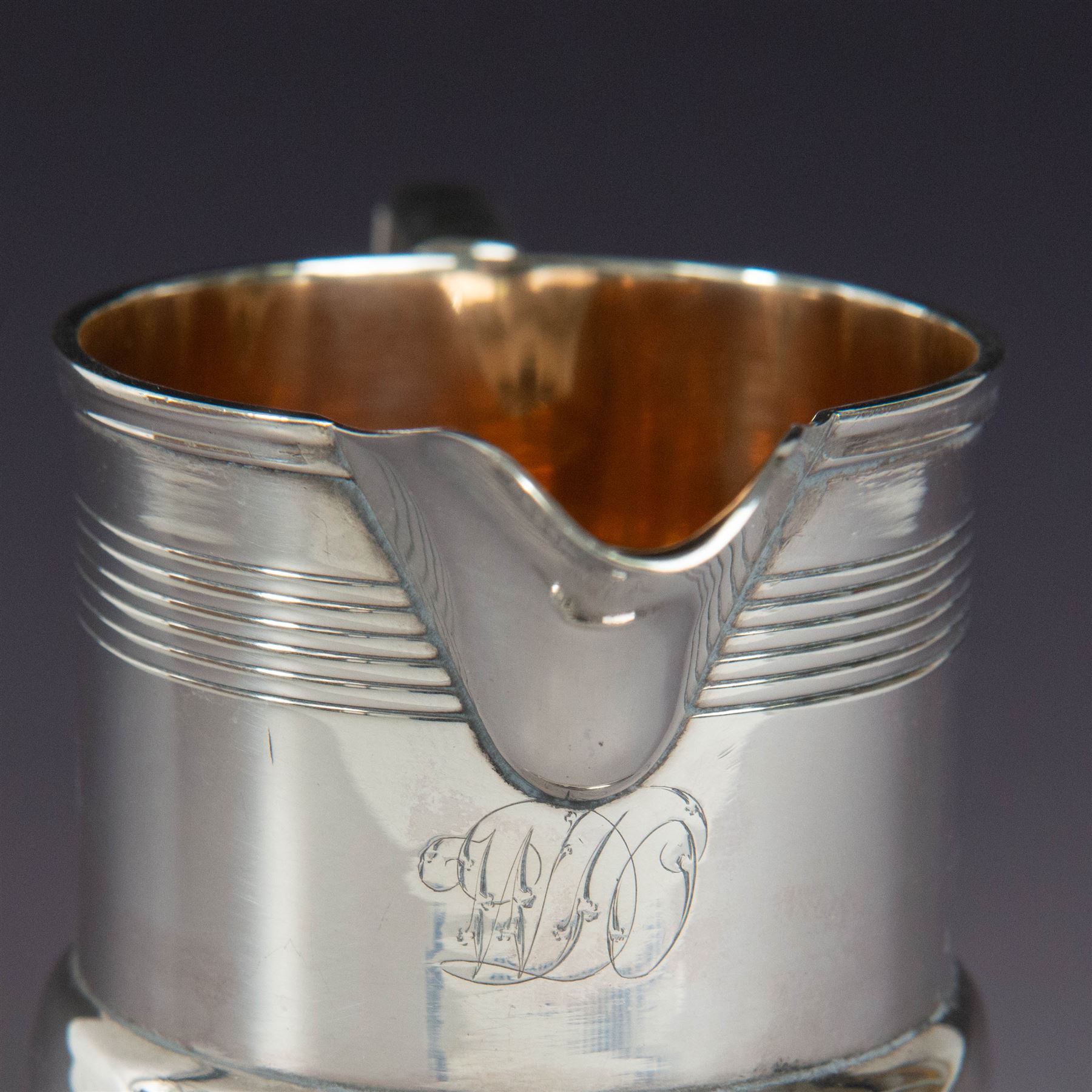 George III silver cream jug, of bellied form with ribbed decoration and angular handle, hallmarked London 1812, maker's mark worn and indistinct