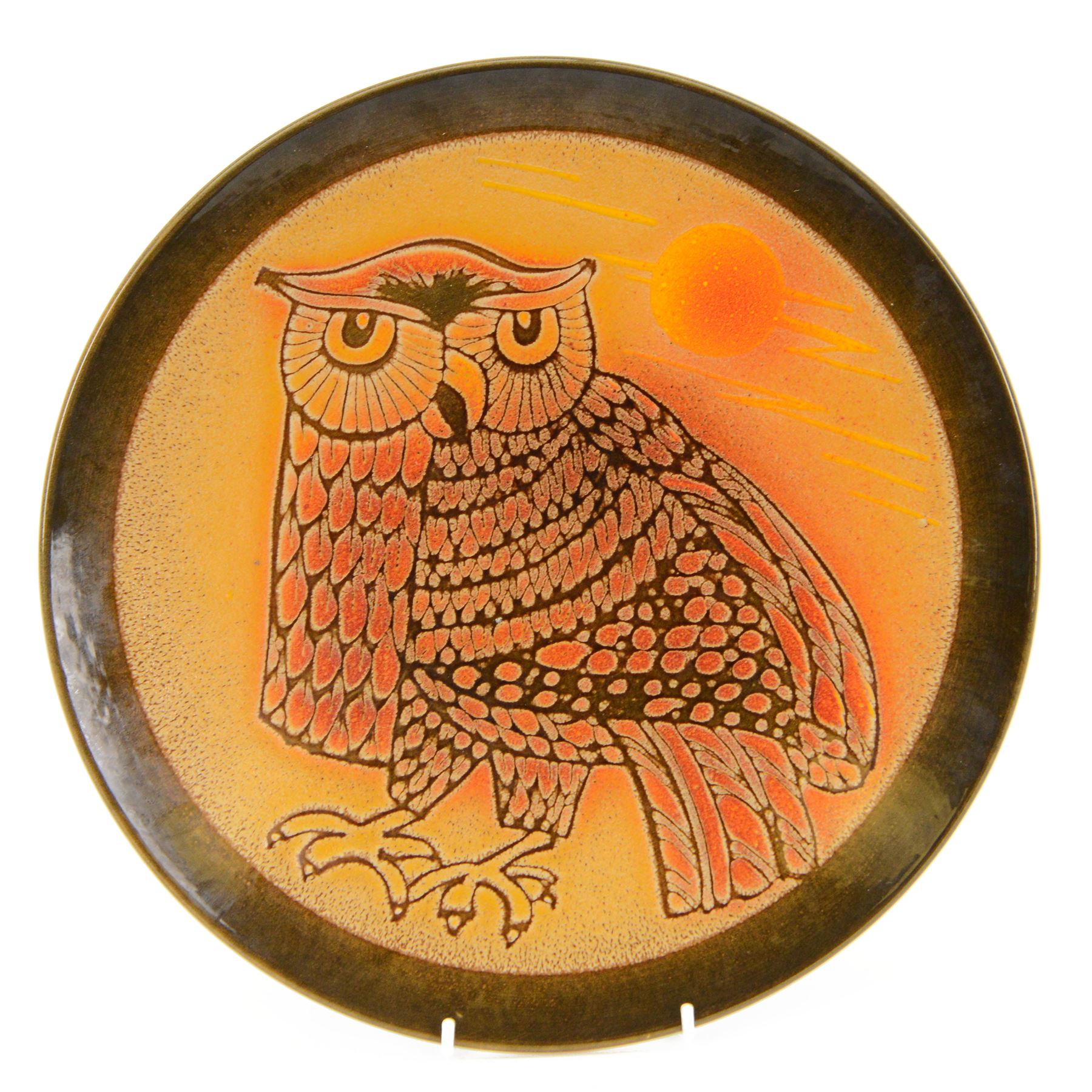 Poole pottery charger decorated with an owl on orange ground signed J. F. Williams, D35cm