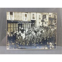 Set of four photographic prints entitled 'The European War 1914 - The Territorials Leave Pickering'; depicting soldiers on parade and marching through the streets of Pickering and ready to embark at the railway station 21 x 29cm; modern mahogany stained frames (4)