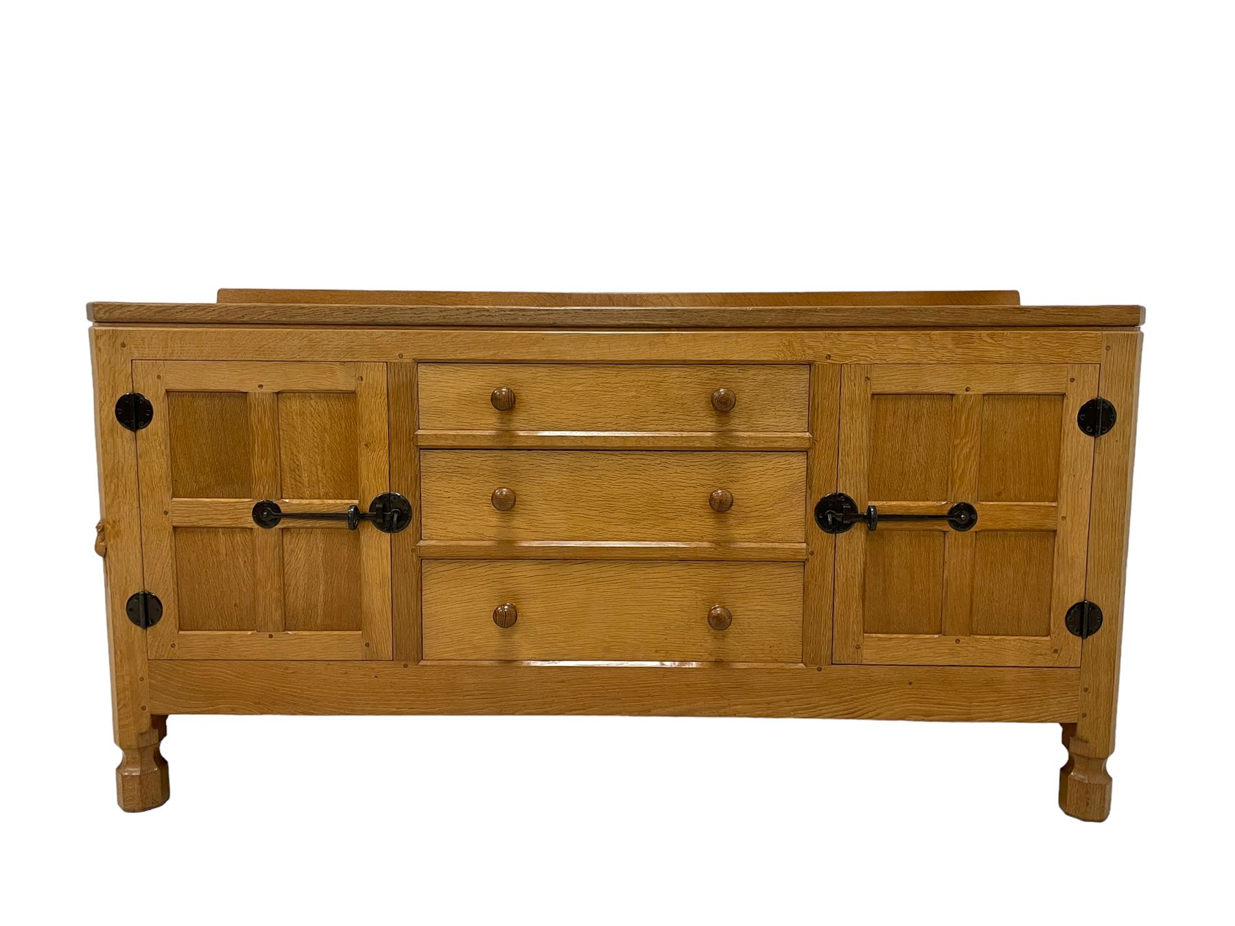 Mouseman - oak dresser, rectangular adzed top with raised back over three central drawers and two flanking cupboards, enclosed by panelled doors with wrought metal fixtures, the canted upright carved with mouse signature, on octagonal feet, by the workshop of Robert Thompson, Kilburn