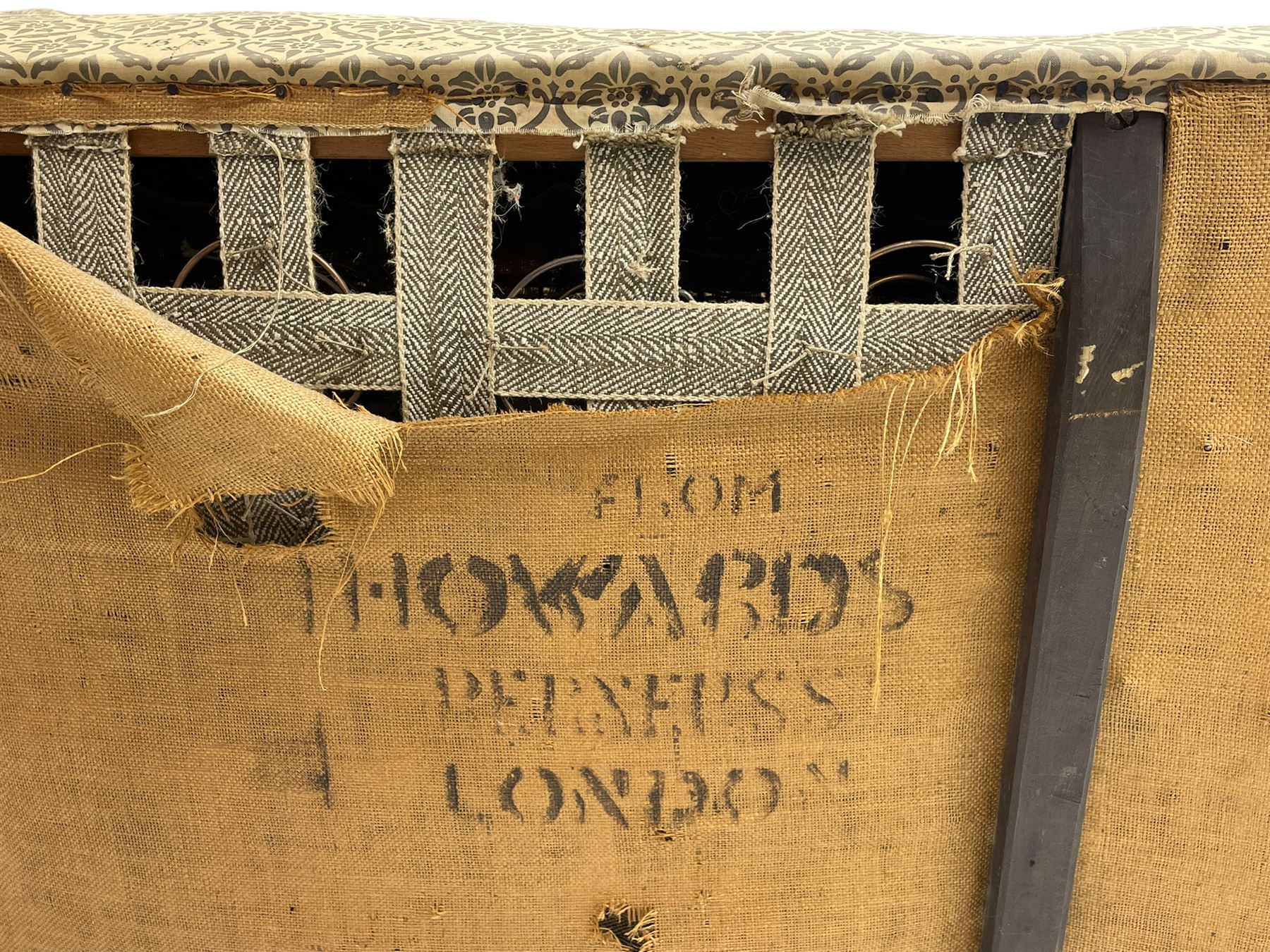Howard & Sons - Edwardian mahogany framed two seat sofa, upholstered in original H&S foliate patterned fabric with sprung seat and overstuffed back and arms, raised on square tapering supports, the rear leg stamped '19600 1795 Howard & Sons Ltd Berners Street'