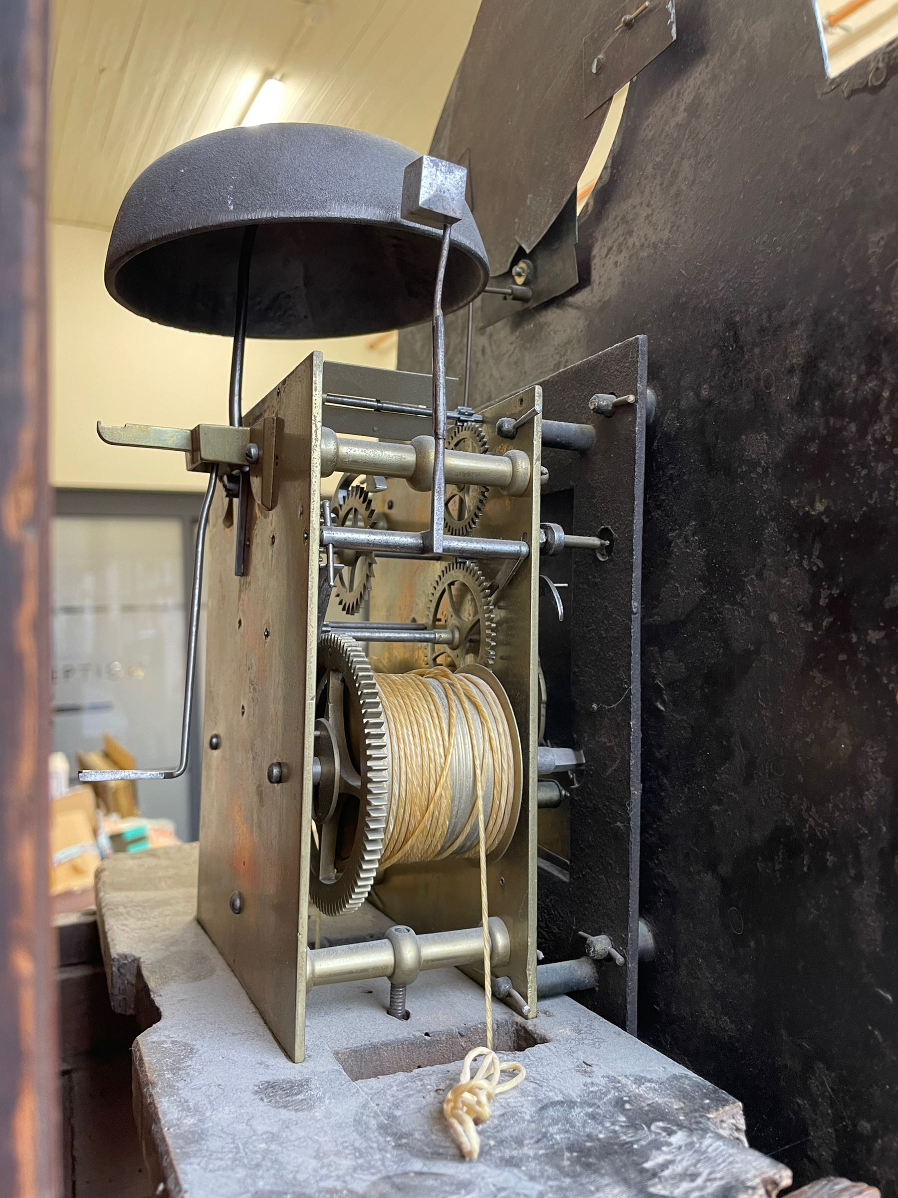 William Gostling of Diss  (Norfolk)-  Late 18th century 8-day oak longcase clock c1780-90, break arch top with scalloped cresting and three brass finials, glazed break arch hood door flanked by turned pilasters with brass capitals, trunk with a long trunk door and rounded top on a square plinth with an applied and shaped skirting, early painted Wilson of Birmingham dial with Roman numerals and five minute Arabic's, matching steel hands and second pointer, arched square ended calendar aperture with date disc behind, floral spandrels within gesso borders and a painted rocking automaton representing Mercury to the break arch, dial pinned via a false plate to a weight driven rack striking movement with a recoil anchor escapement, striking the hours on a cast bell. With pendulum weights and key. 
William Gostling (II) is recorded as working in Diss from 1774 to 1797, succeeded by widow Anne and son George . The dial of this clock is illustrated and discussed in detail in M.F. Tennants book 