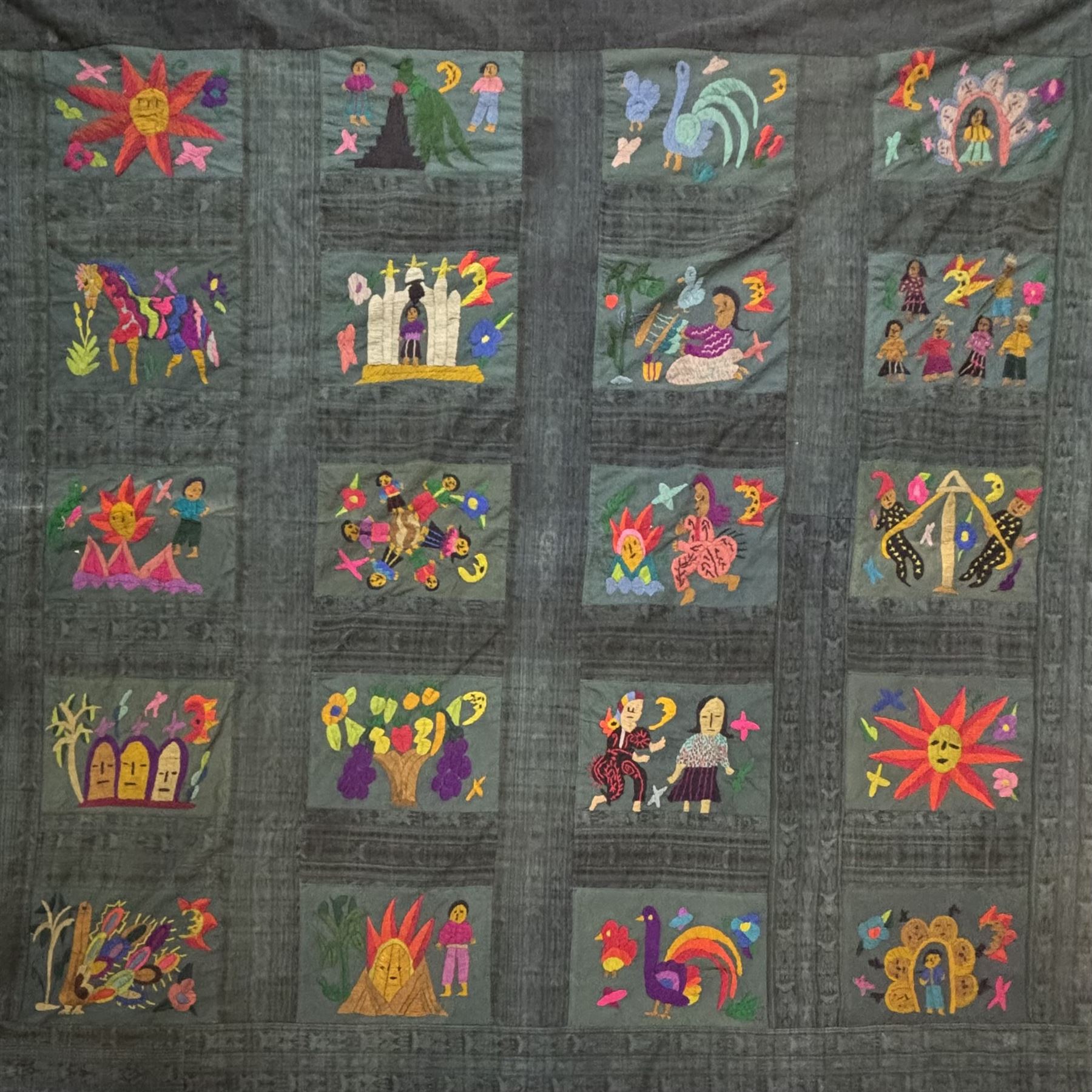 Guatemalan hand stitched wall hanging panel, naively embroidered with figures, animals, and flowers in a bright pallet, upon a dark green ground, approximately H230cm W115cm