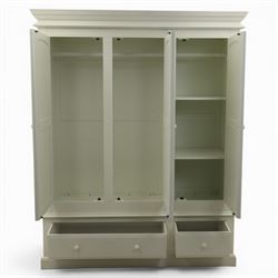 Modern white three door wardrobe, with two hanging section and shelving area, above a long drawer and a short drawer to the base, raised on a moulded plinth