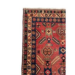 Near pair of Persian Azerbaijan red ground runners, each rug decorated with Nazarlik and stylised leaf motifs, enclosed with three band border decorated with flower heads and geometric motifs 

406cm x 99cm 
409cm x 102cm
