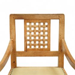 Mouseman - set of eight (7 + 1) oak dining chairs, pierced and carved lattice back over leather upholstered seat, on octagonal front supports united by stretchers, carved with mouse signature, by the workshop of Robert Thompson, Kilburn