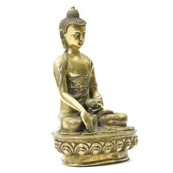 Late 19th/early 20th century brass Buddha in lotus position holding a 'singing' bowl H21cm