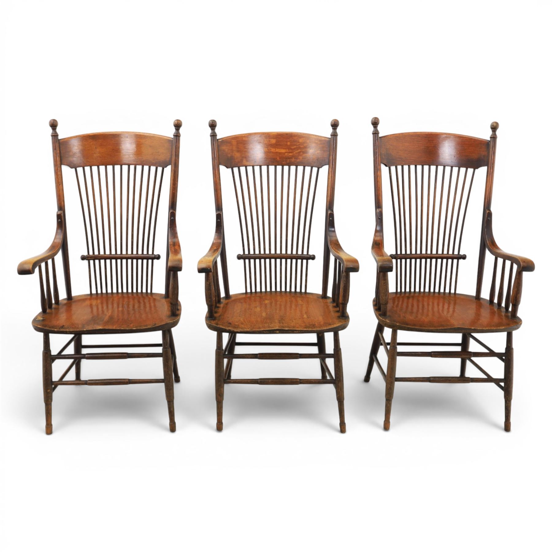 Set of three 19th century ash and elm spindle back Windsor armchairs, arched top rails above fan-shaped spindle backs, curved arms with turned supports, shaped saddle seats, on turned legs joined by H-stretchers
