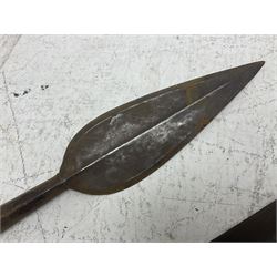 Native long-shafted spear, the large iron head with central medial ridge and decorative neck, on plain circular haft L260cm; and another similar Native long-shafted spear with cane haft L249cm (2)