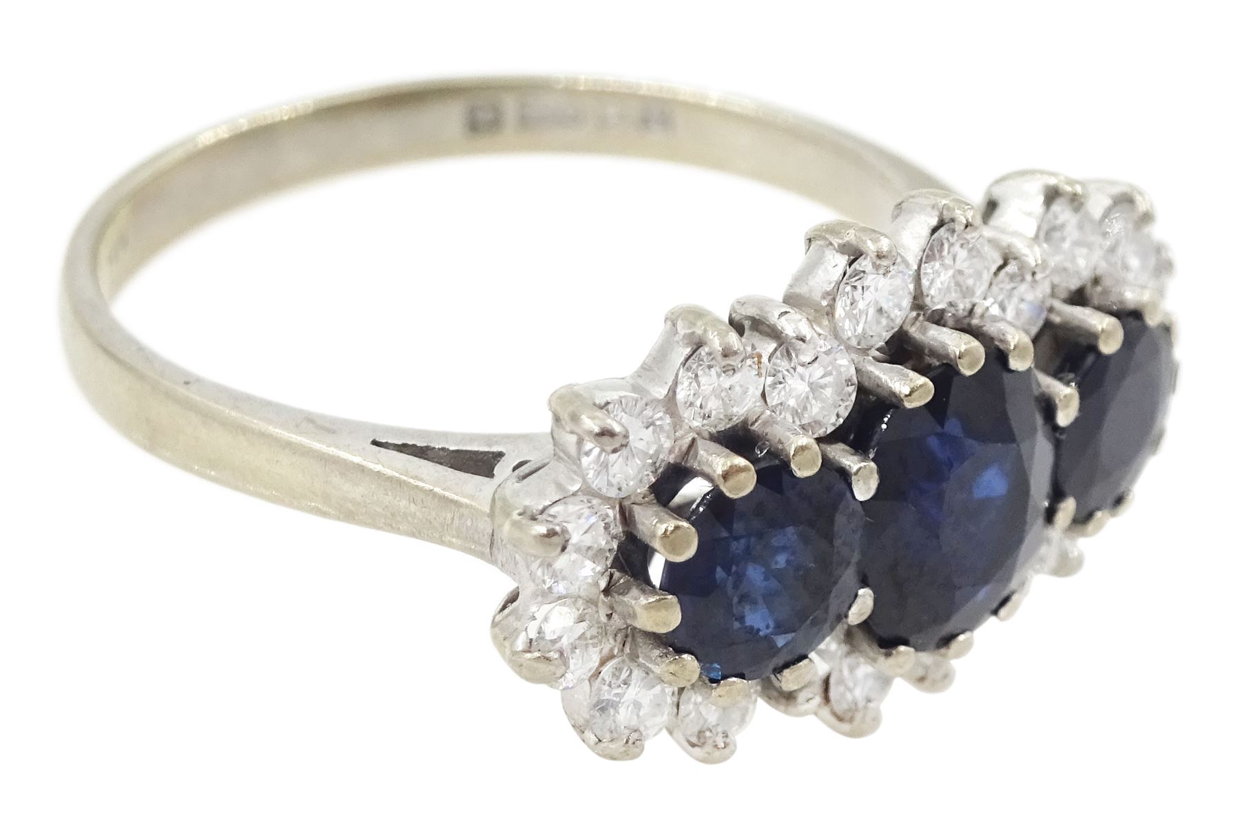 18ct white gold three stone oval and round cut sapphire and round brilliant cut diamond cluster ring, London 1986, total sapphire weight approx 1.80 carat, total diamond weight approx 0.60 carat