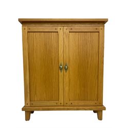 Andrena - light oak side cabinet, two panelled doors enclosing two shelves flanked by two CD racks