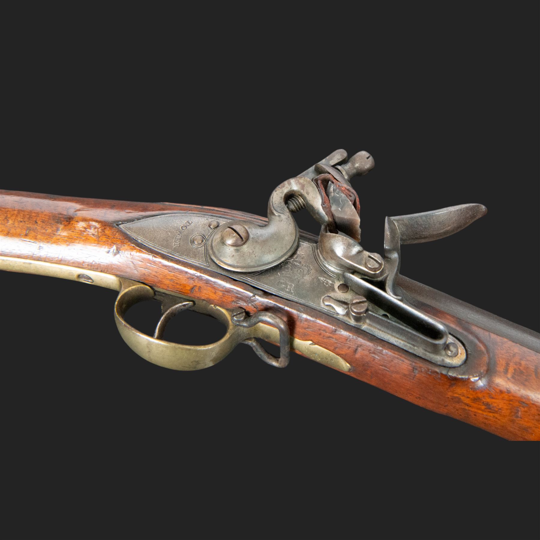 Brown Bess flintlock musket, 37in barrel, action marked with crowned GR and Tower, with brass mounts, the thinned butt marked 38, sling swivels, steel ramrod, overall L132cm
