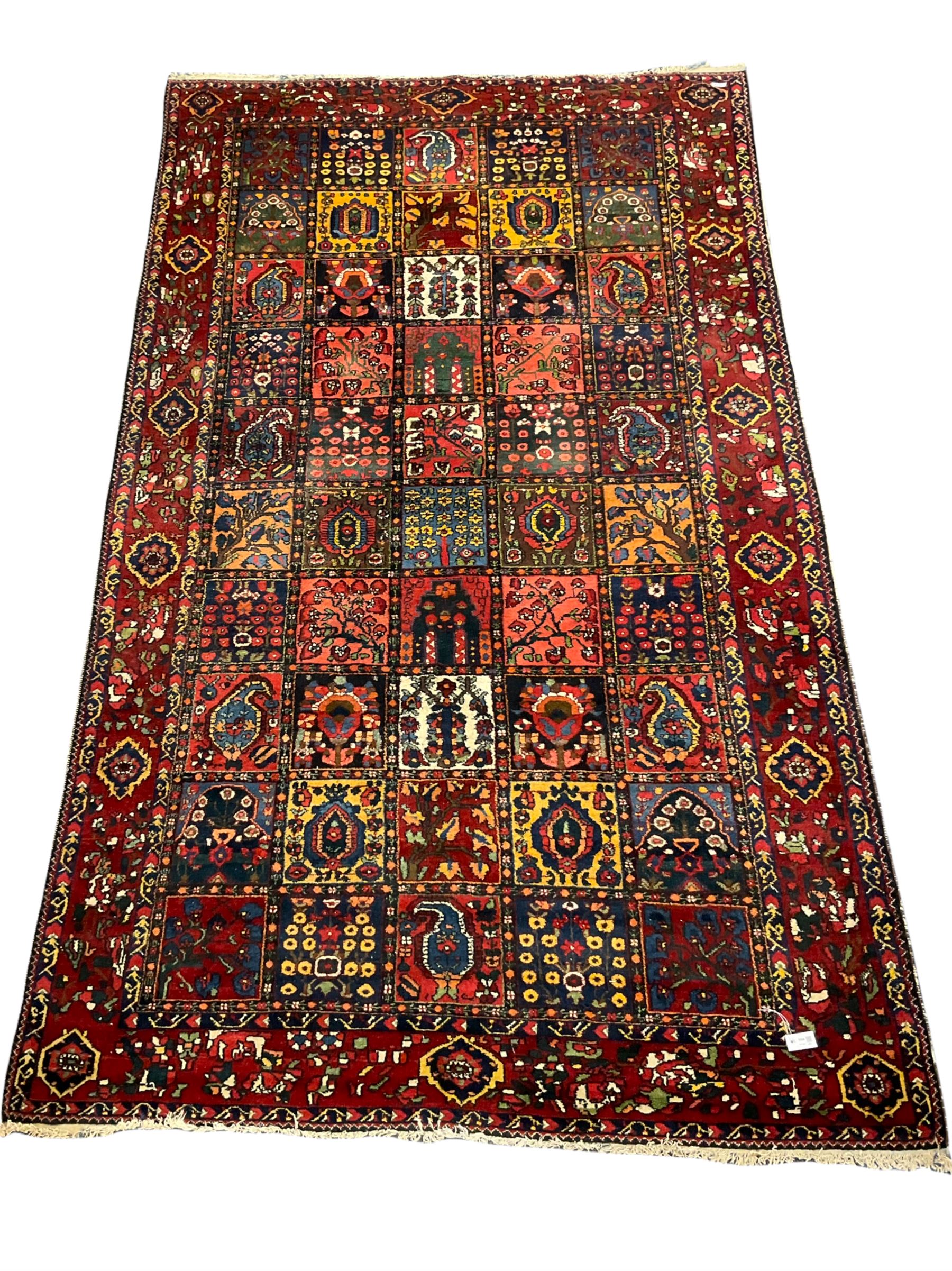 Large Persian garden rug, multiple rectangular panels decorated with stylised plants, Boteh and tree of life motifs, the outer guarded border with floral design 