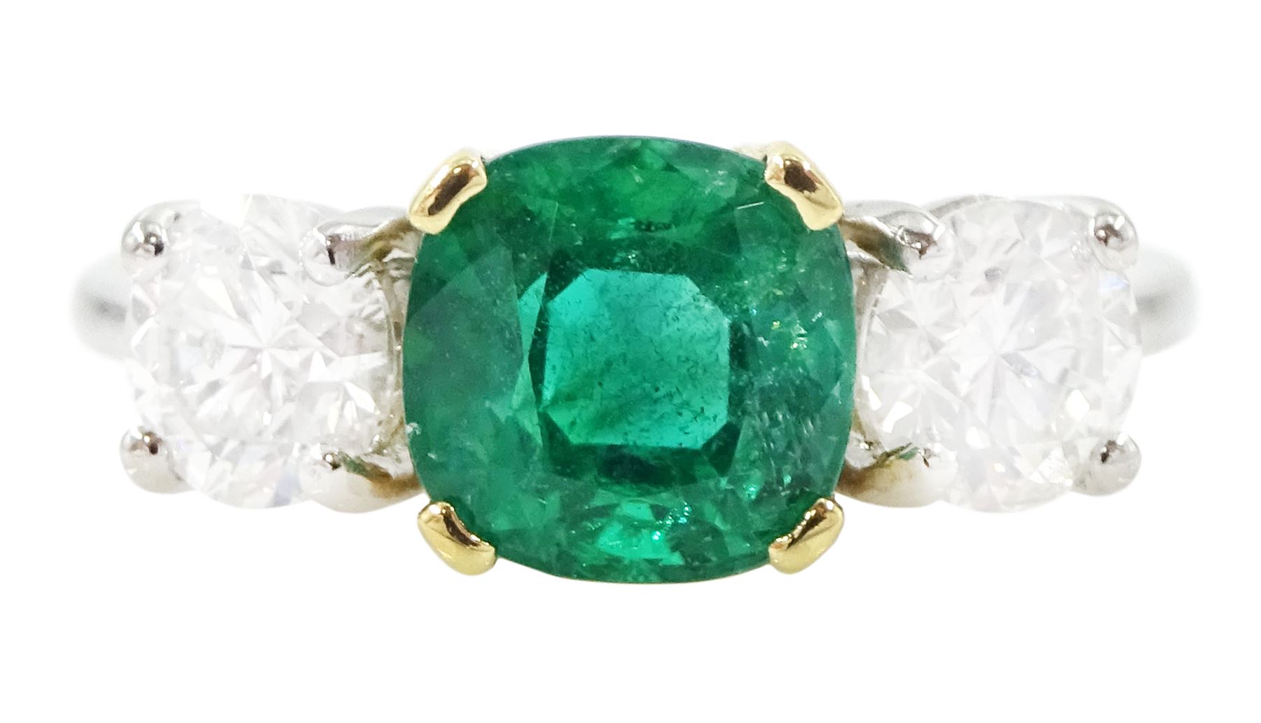 Platinum emerald and diamond three stone ring, single cushion cut emerald of approx  1.85 carat, set with a single round brilliant cut diamond either side, hallmarked, total diamond weight approx 1.20 carat