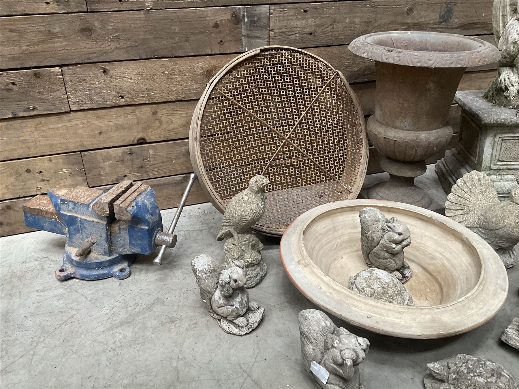 Small Victorian style cast iron urn, cast stone griffin on plinth, 13 garden figures, old vice and other items. 