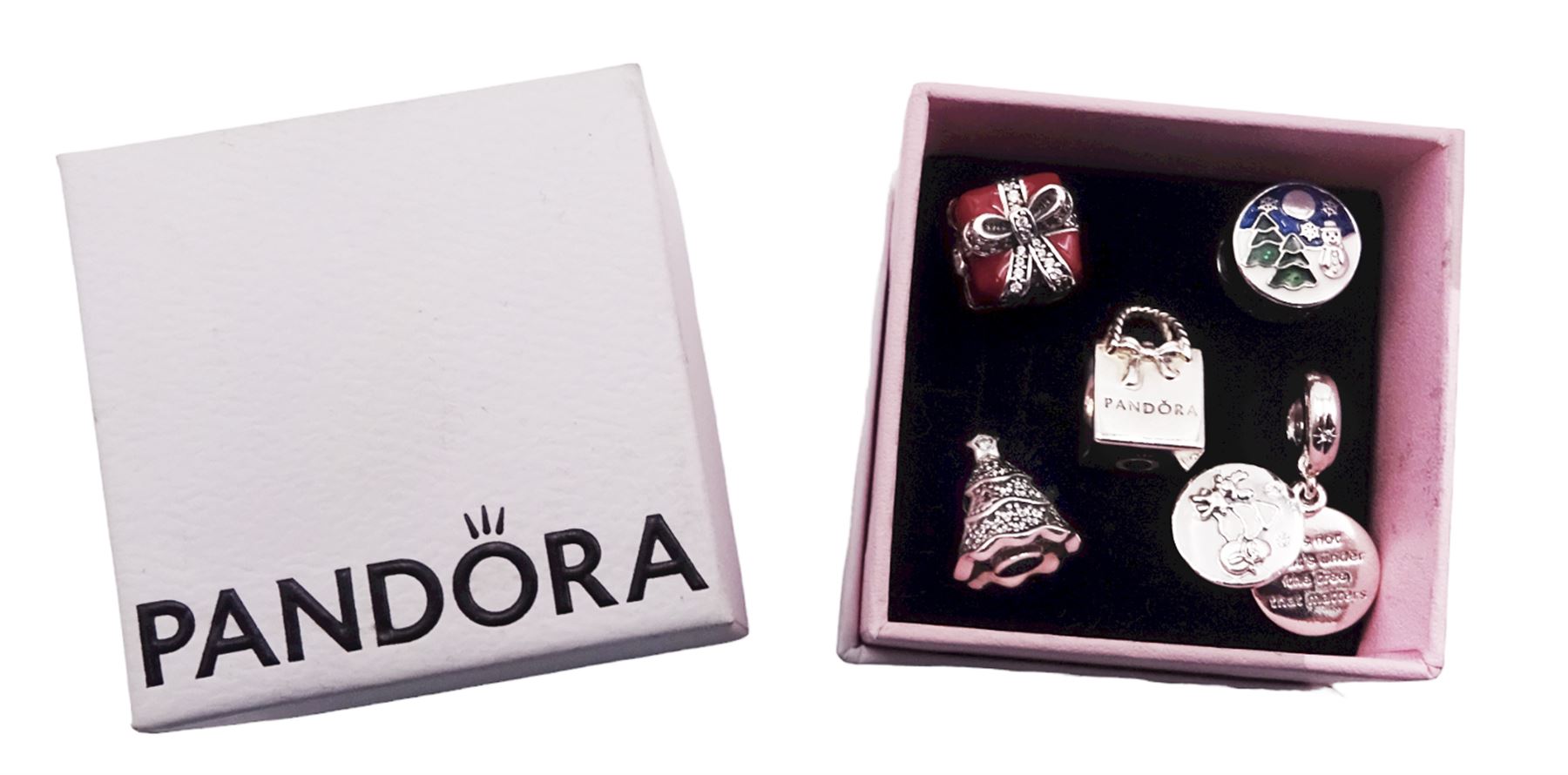 Five silver Pandora charms including Pandora shopping bag, Christmas tree, wrapped present, Winter scene, and snowman with reindeer droplet charm, all stamped S925 ALE, with one Pandora box 