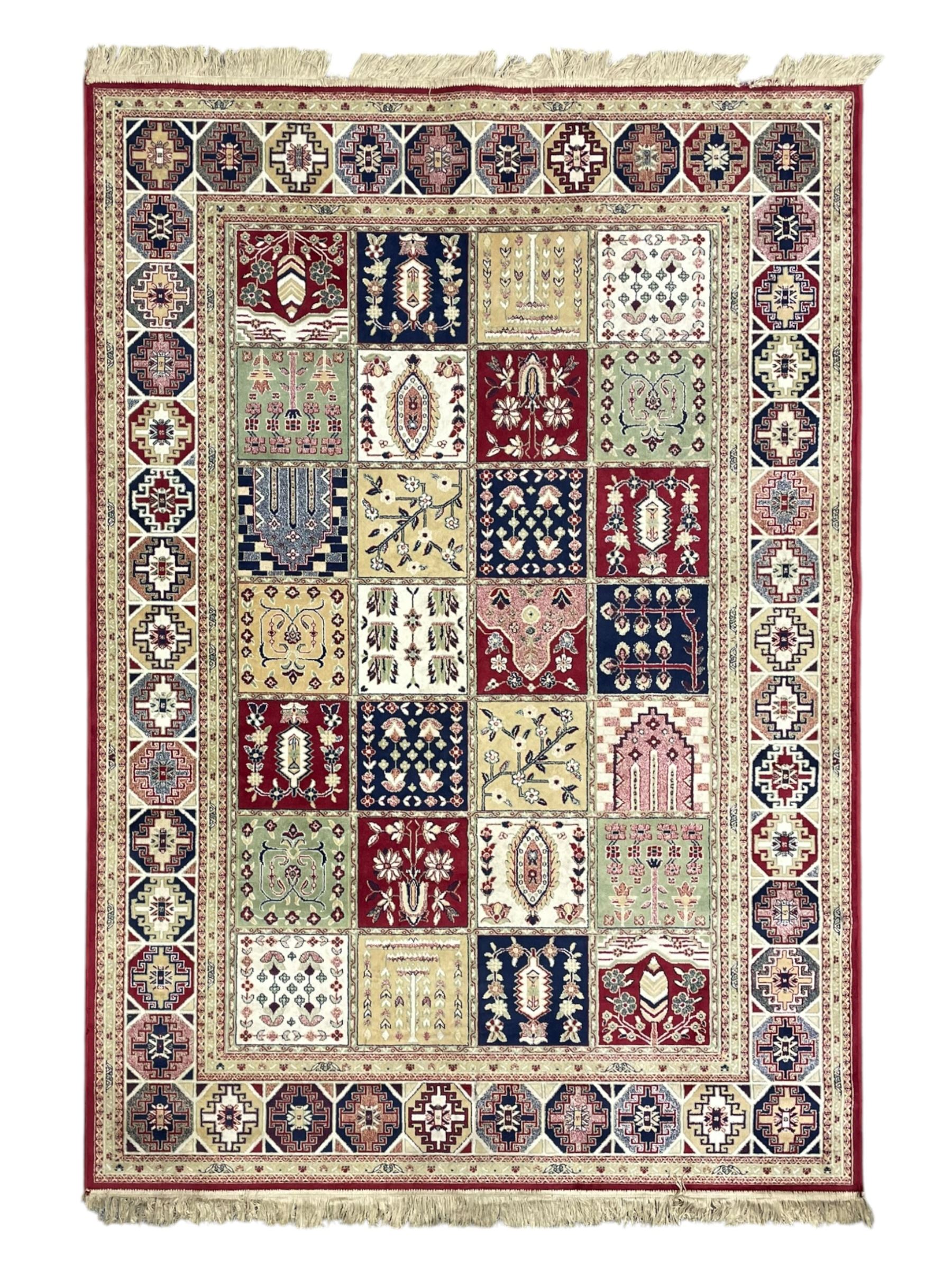 Bakhtiari design rug, the field divided into panels each decorated with tree of life and floral motifs, the main border decorated with Hac motifs 