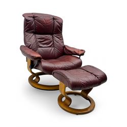 Ekornes Stressless, swivel armchair upholstered in red leather, with matching footstool su...