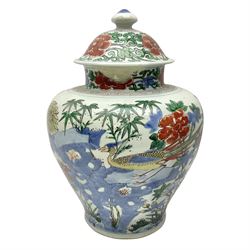 19th century Chinese Wucai vase and cover, decorated  with peacock on blue rockwork and other birds flying amongst tree peonies, H43cm