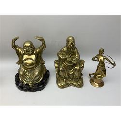 Brass buddha, with palms facing upwards on a wooden plinth, together with other brassware including two shell case vases 