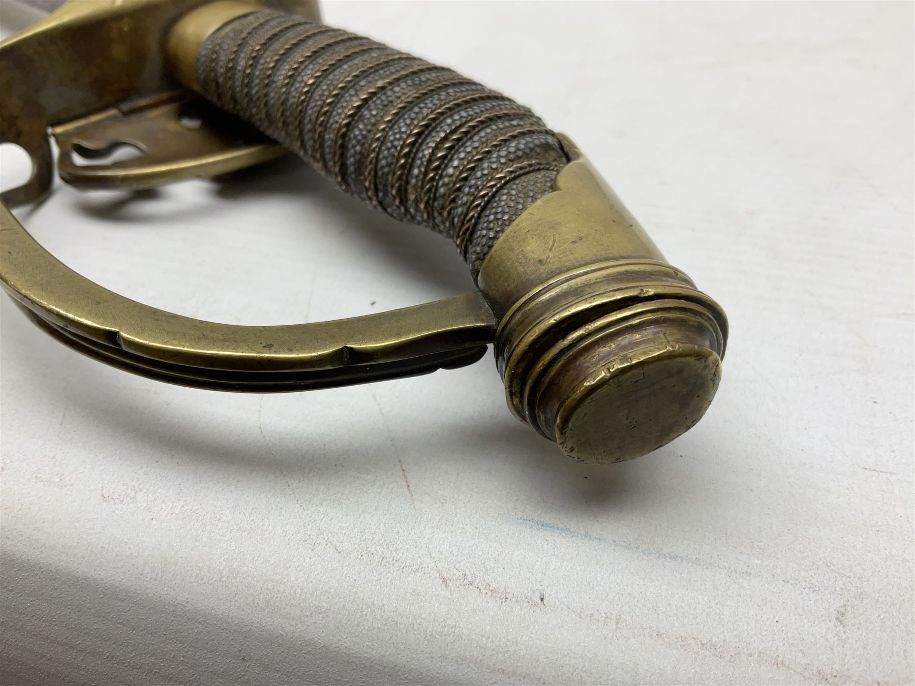19th Century Prussian Infantry Officers 1889 pattern sword, the 77.5cm double fullered blade with makers mark to the ricasso for Weyersberg Kirschbaum & Co; curved brass top pommel with brass wire bound fish skin grip applied with crowned  Wilhelm II monogram; folding cross guard with Imperial eagle and double bar knucklebow; in polished steel scabbard with single suspension ring L94.5cm overall