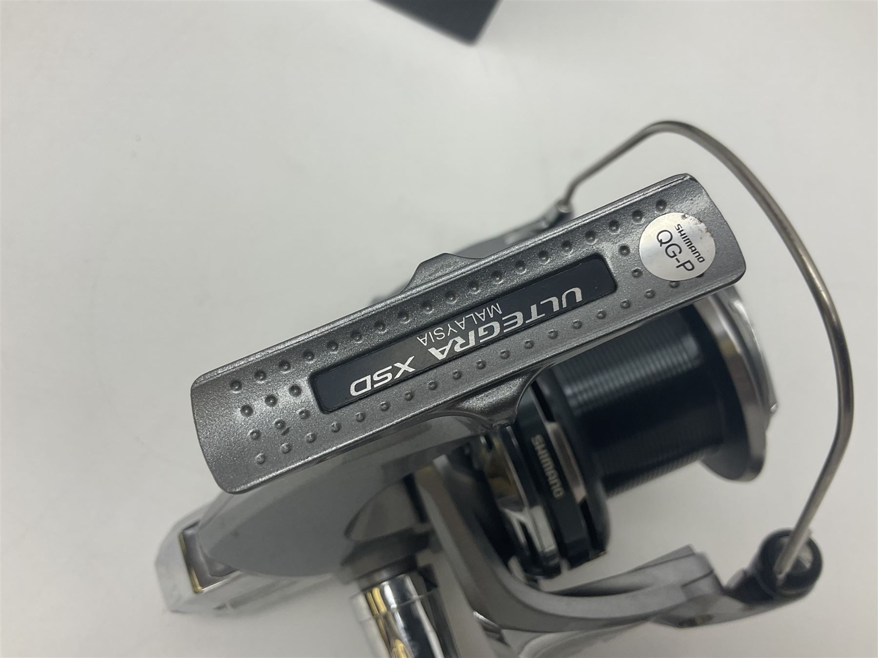 Four fixed spool reels, all in original boxes, comprising Shimano Ultegra 5500 XSD, with spare spool, Mitchell Autosurf 700, with spare spool, Shimano Sedona 600 FB with spare spool and D.A.M Quick 5001