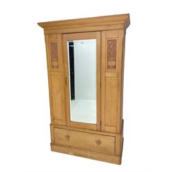 Victorian pine wardrobe, single mirror door and drawer to base, the panelled front carved with floral planters