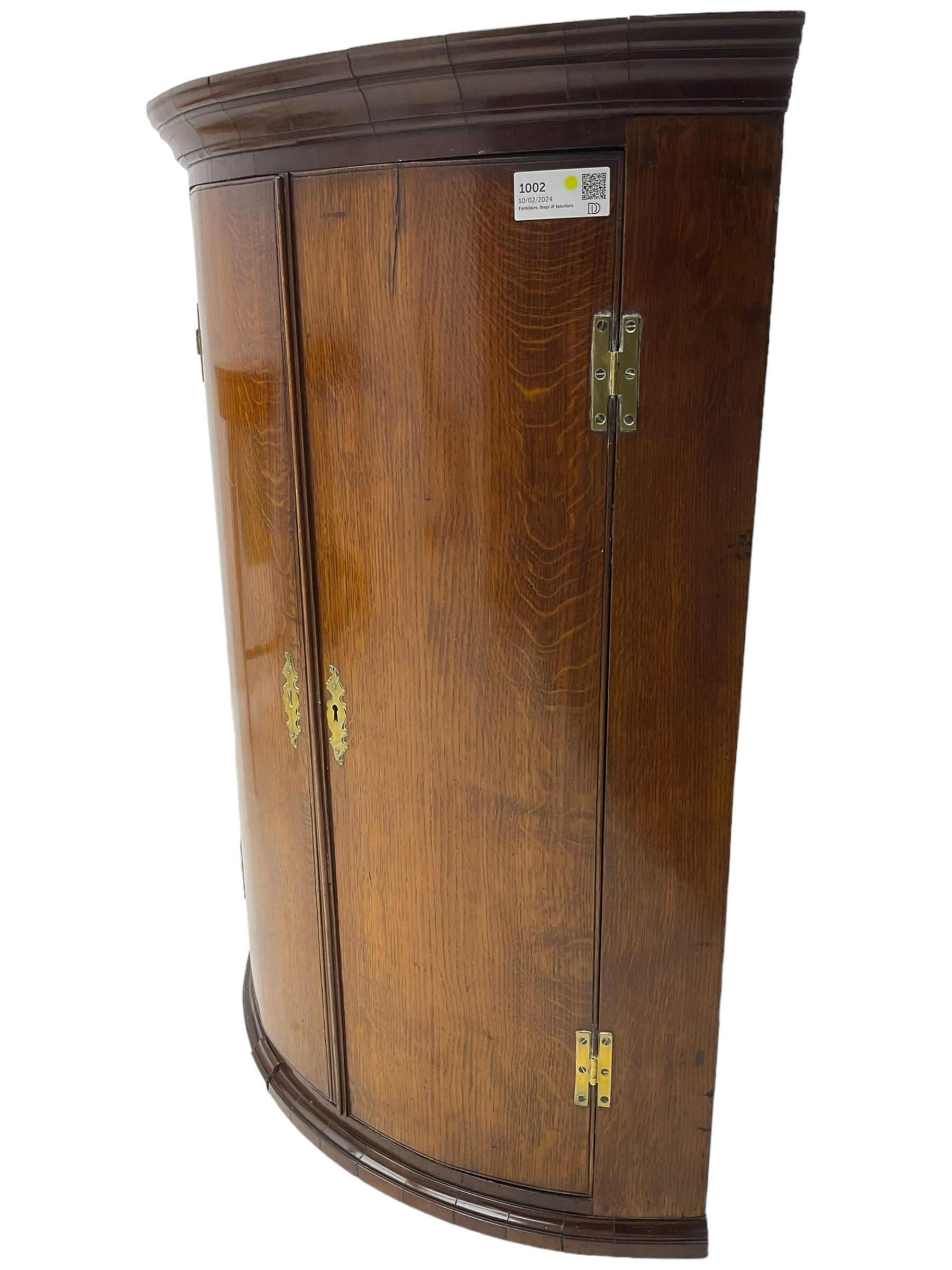 George III oak and mahogany wall hanging cylinder corner cupboard, moulded cavetto cornice over double cupboard enclosing three shelves