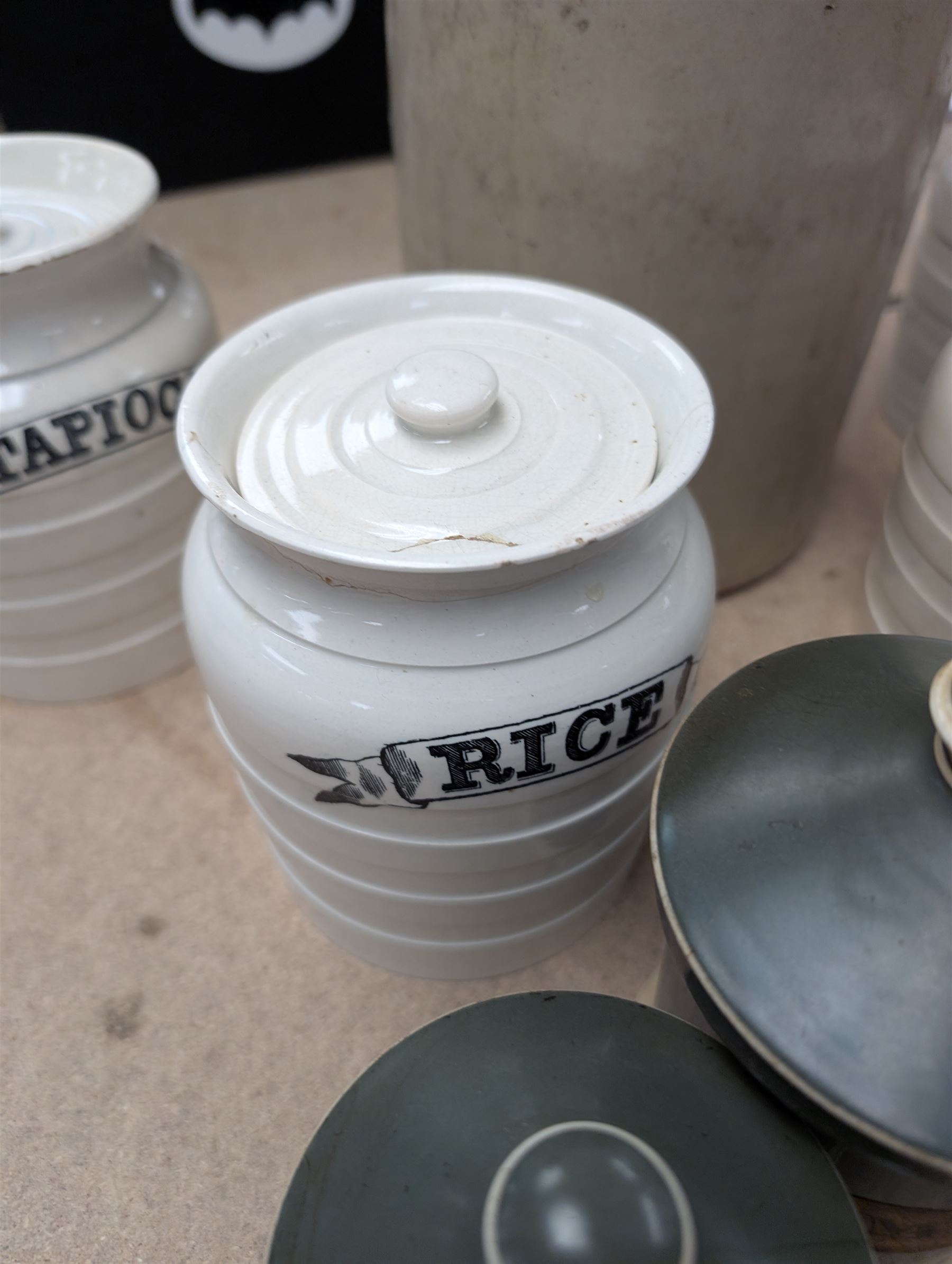 19th century sage green apothecary jars with gilt labels, four white ceramic kitchen jars and a stoneware flaggon marked Wheat Wine