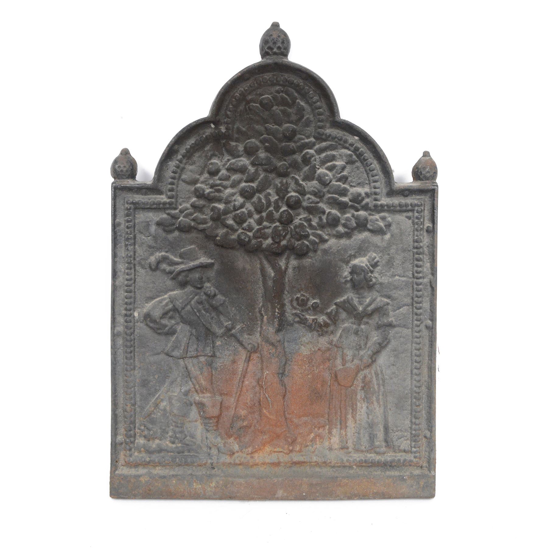 Cast iron fire back, depicting a couple under a tree with three acorn finials, H74cm