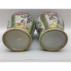 Pair of 19th century Chinese Famille Rose vases and covers, each of baluster form with twin gilt lion mask ring handles to shoulders, the flattened domed covers with gilt temple lion finials, each decorated with alternating reserves of bijin and attendants, and birds and butterflies amongst blossoming peonies, against a gilt ground profusely decorated with stylised scrolls, H32.5cm