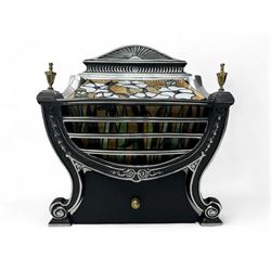 Stained glass and cast iron electric fireplace, arched top with decorative finials, stained glass front panel with floral motifs, flanked by cast iron scrolls, raised on scroll supports