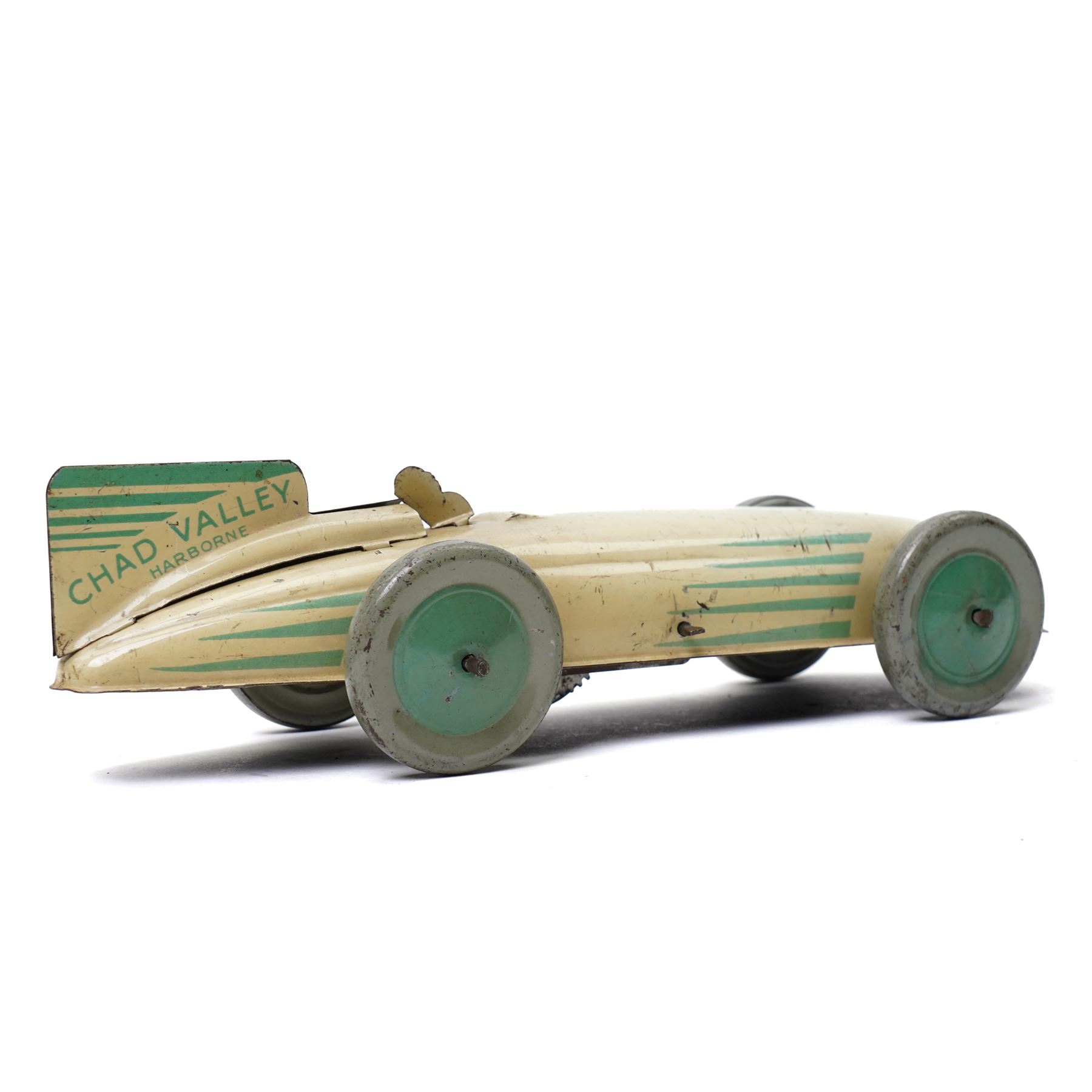 Chad Valley Harborne tin plate and clockwork racing car, cream and green with matching green hubs, length 20cm
